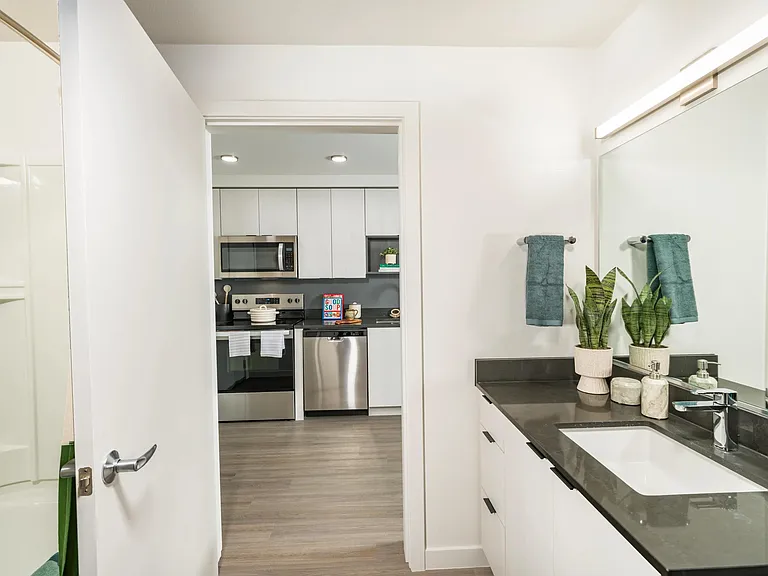 Indulge in designer bathrooms at Modera Woodstock, featuring sleek quartz countertops for a touch of luxury.