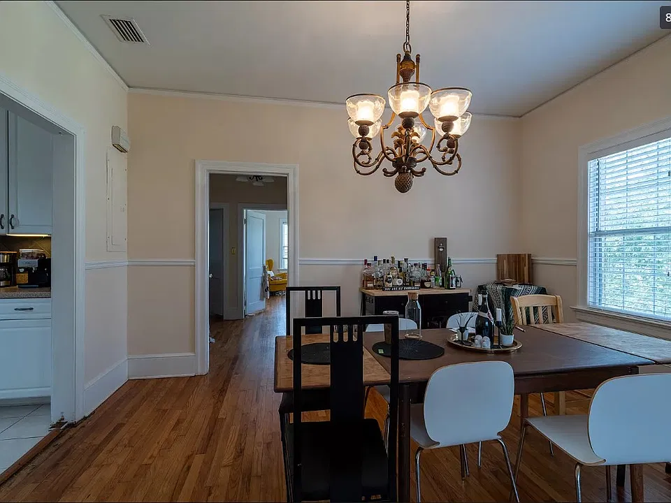 Huge formal dining room with beautiful chandelier.