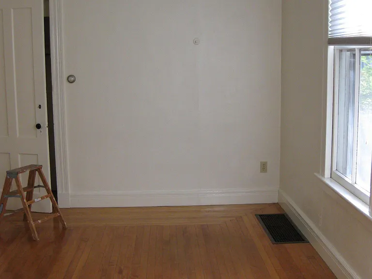 Larger bedroom with view onto side yard. Measures approximately 134 sq. ft.