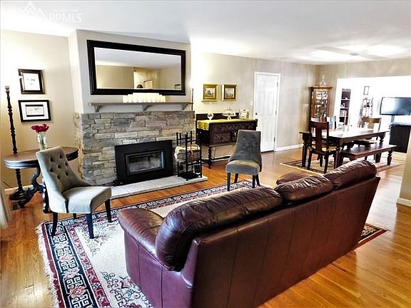 As you walk in the door you are greeted by the warm wood flooring, and stone fireplace