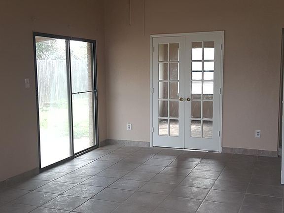 Light and bright living room with access to large back yard! French doors lead to bedroom or office.