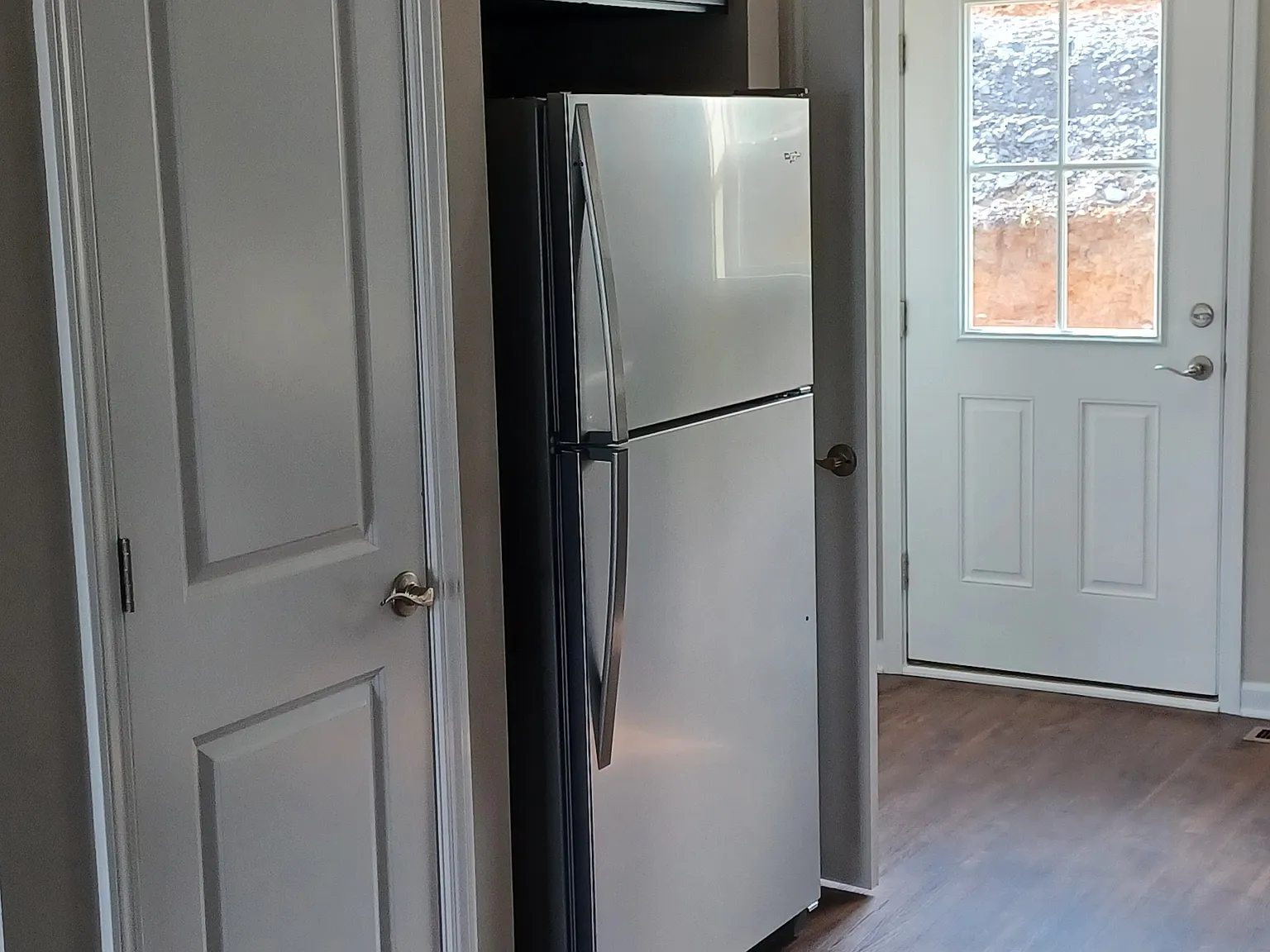 In kitchen, looking towards back door.