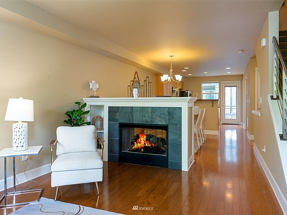 A cozy double-sided gas fireplace warms both the living and dining spaces. 