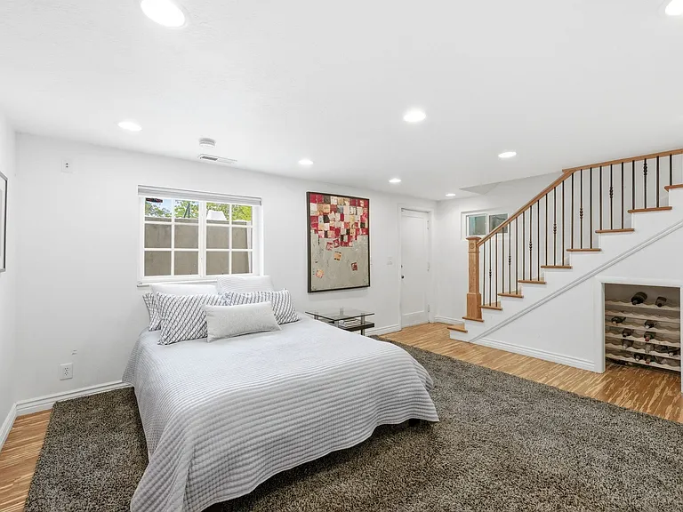 Main room on the lower level. Can be used as additional family room with adjacent bedroom and bathroom or as a master suite and office as pictured.