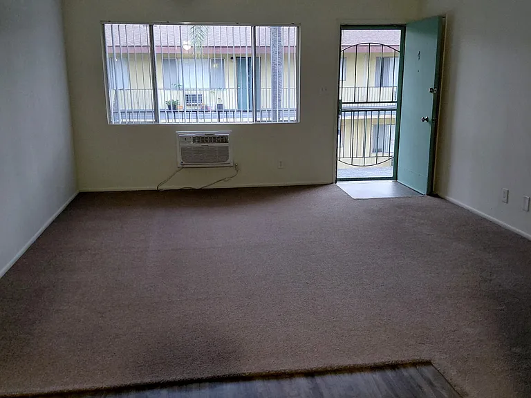View from kitchen to large front window and door.