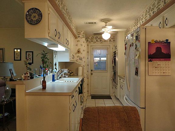 Kitchen is light and bright.  Offers built in microwave, dishwasher, flat surface cooktop and wall oven.  Home is all electric
