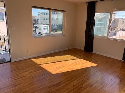 Living room with lots of light and 2 windows.