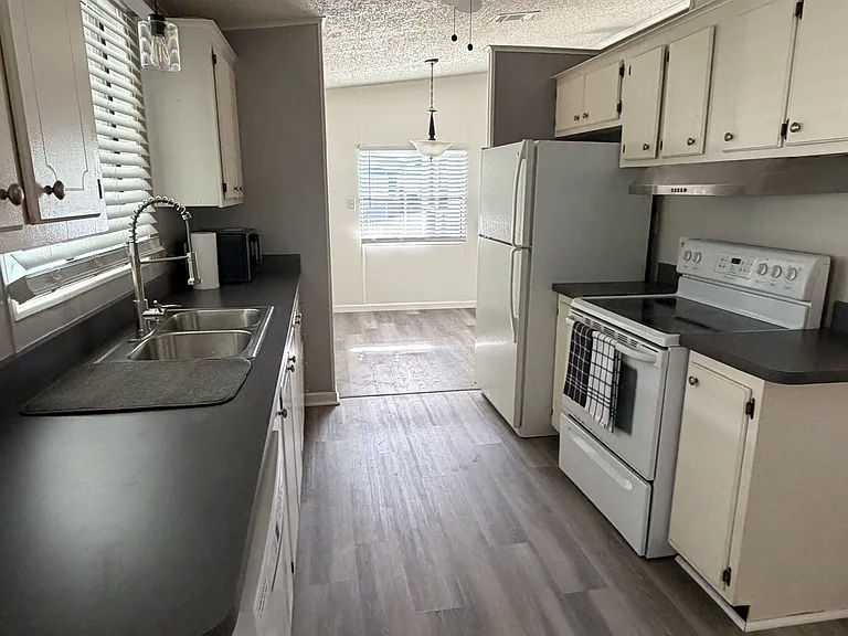 kitchen with dishwasher/garbage disposal, fridge with ice maker