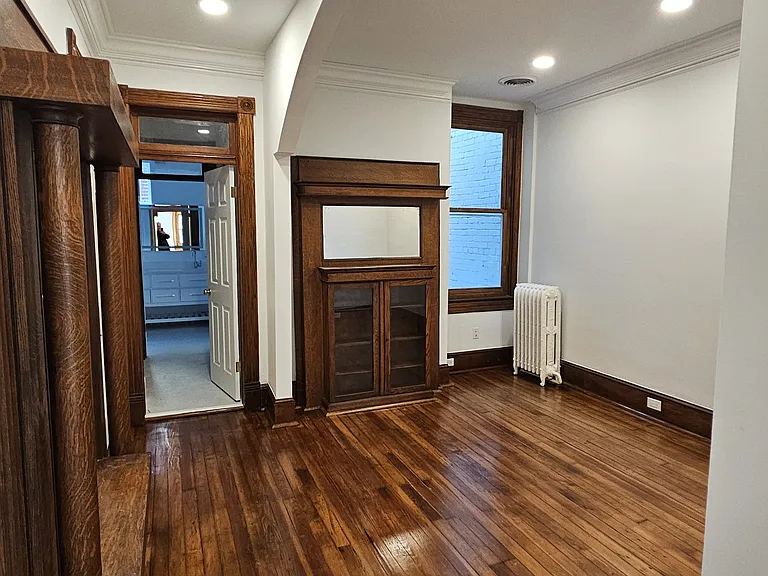 2nd floor suite: bedroom with arch and two antic mantles and door to rear bathroom and walk-in closet.