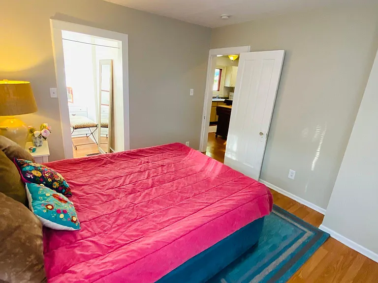 The view of the Third bedroom from the two windows shows the walk-in closet entrance and door leading to the kitchen and second bath.