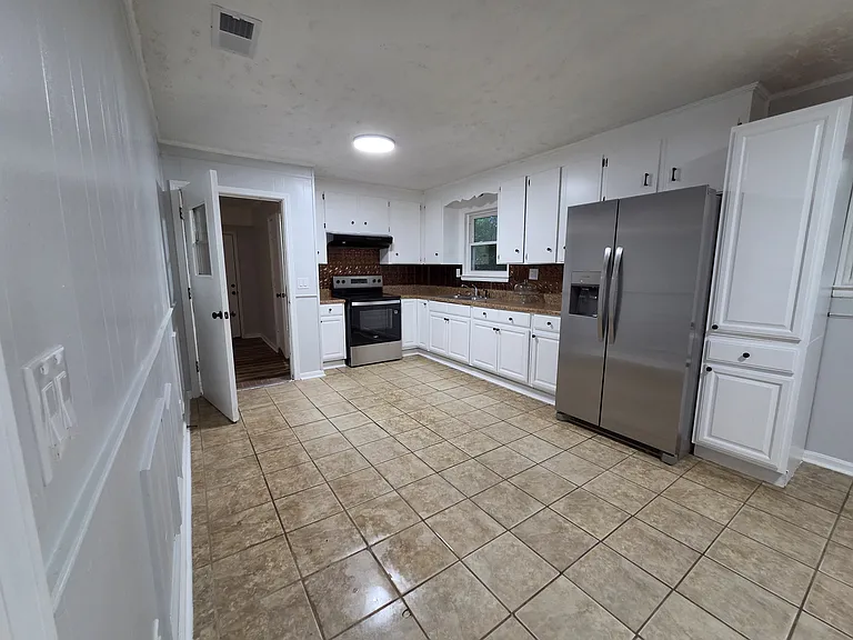 Huge eat in kitchen with lots of cabinet space and pantry