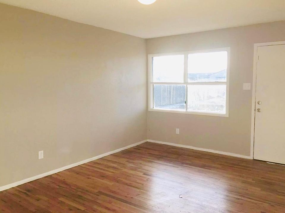 living room looking out front window and entry