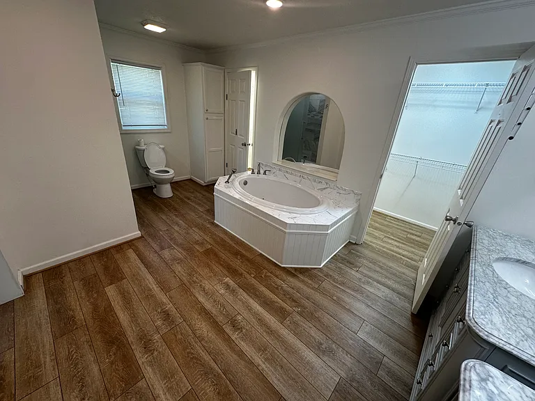 Master bath with Jacuzzi tub and movable shower head. His and her sinks. Walk in shower. His and her sinks.
