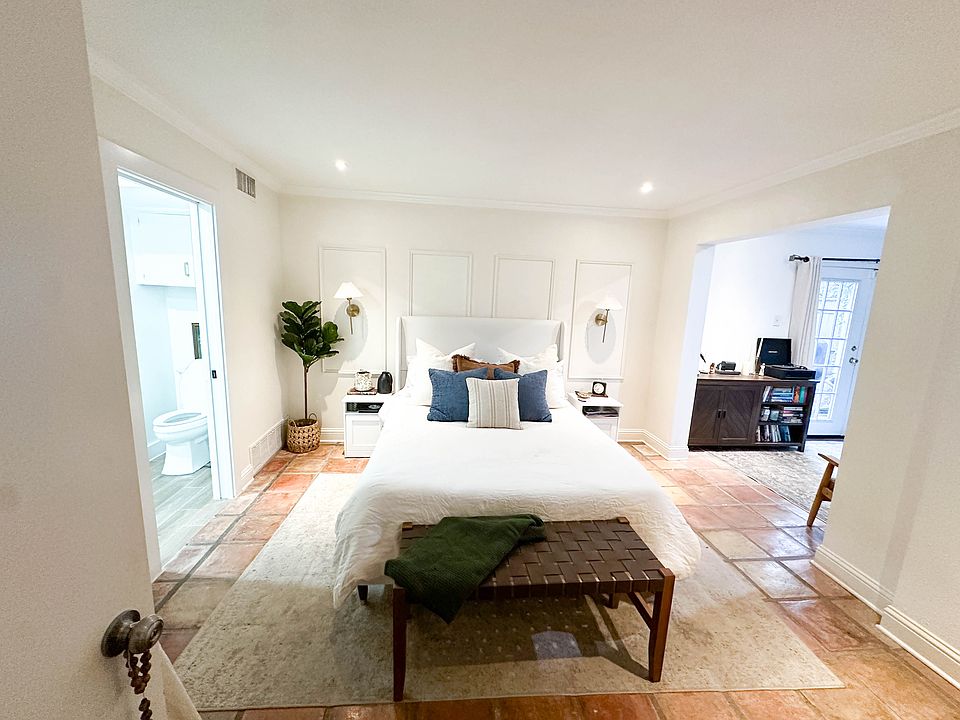 Downstairs bedroom with bonus room attached and patio