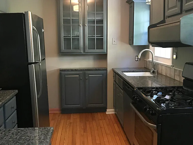 Kitchen w granite and stainless steel appliances