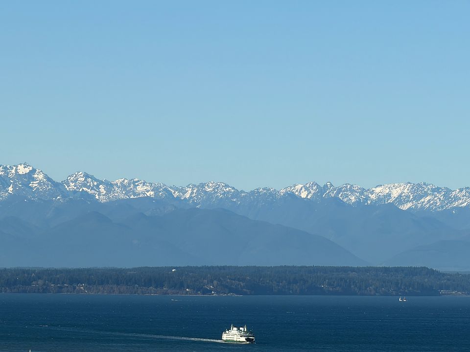 Olympics, and water views can be seen from living room, primary bedroom, and rooftop deck
