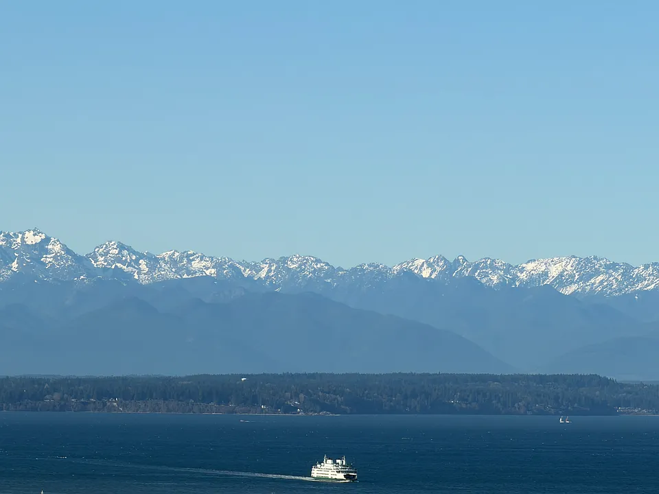 Olympics, and water views can be seen from living room, primary bedroom, and rooftop deck