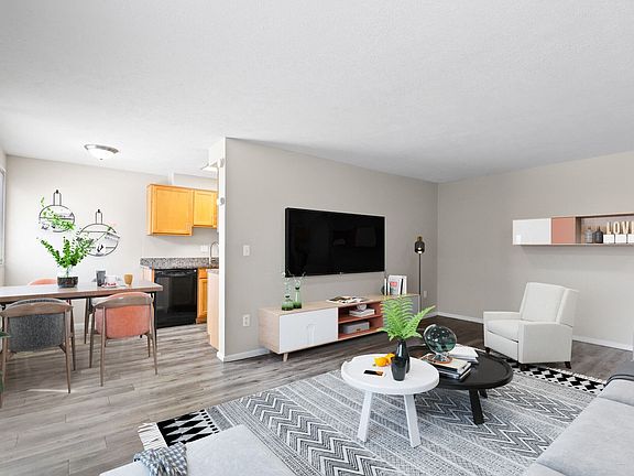 Open living area with modern finishes and kitchen view