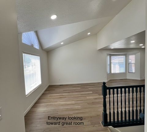 Great room with large front window and side bay window with great lighting.