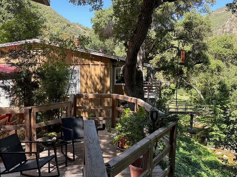 Bungalow wrap around redwood deck looking over creek