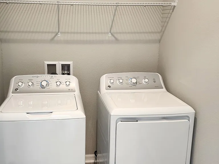Laundry room with full size washer and dryer.