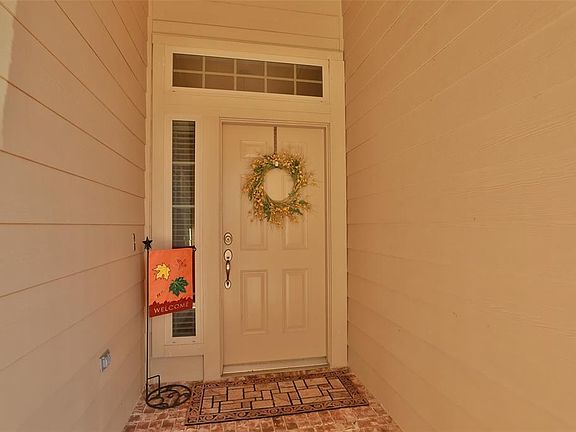 PRETTY FRONT DOOR: A transom over the door and a sidelight add architectural interest at the entrance.