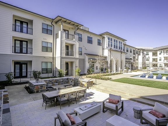 Relax in style by the poolside with spacious lounge chairs at Modera Walsh's expansive swimming pool.