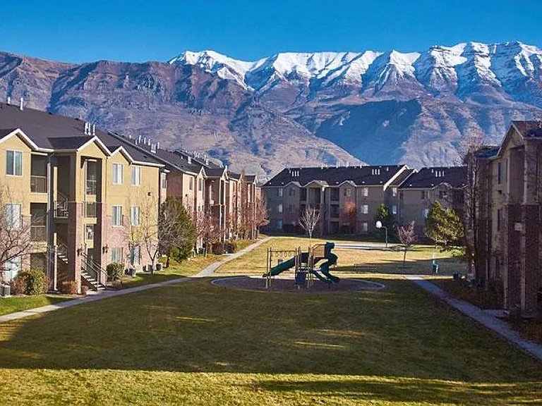 Spacious courtyard with playground, and mountain views.