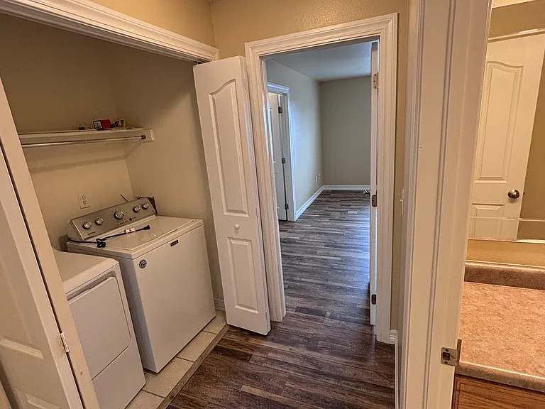Laundry closet with washer and dryer.