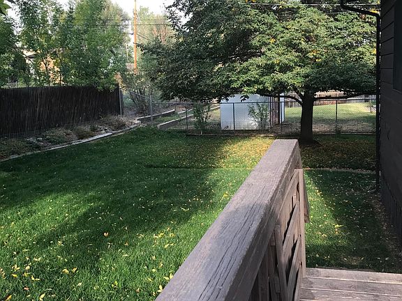 Flower beds, trees off of deck.