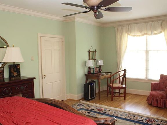 The view from the bed overlooks a large room with a seating