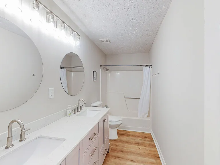 Spacious full bath with a long double-sink vanity, ample storage, and a tub/shower combo for easy daily routines.
