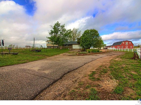 Picturesque red barn is a heated work shop with concrete floor through out except one stall area.  The second floor has been framed and wired for a caretaker apartment, but is not completed.