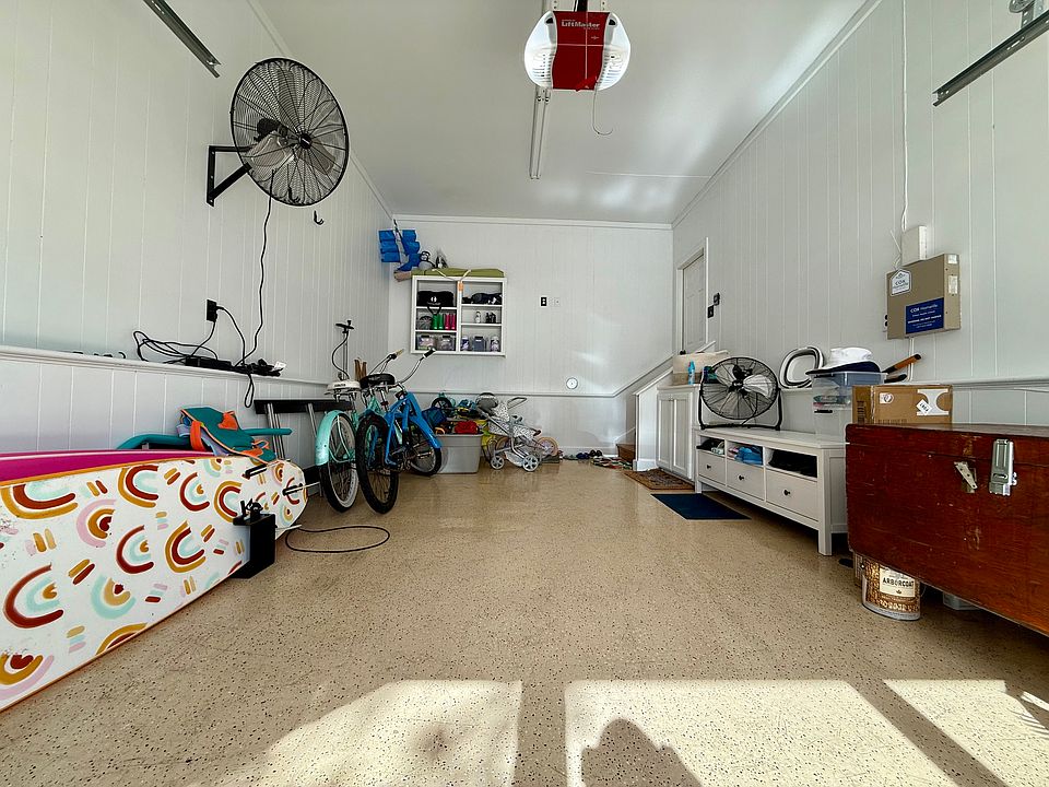 Large recently painted garage with beach buggy, beach chairs, and two beach cruiser bikes to maximize enjoyment while at the beach.