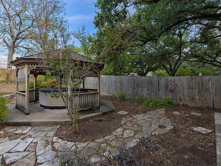 Back yard features a hot tub