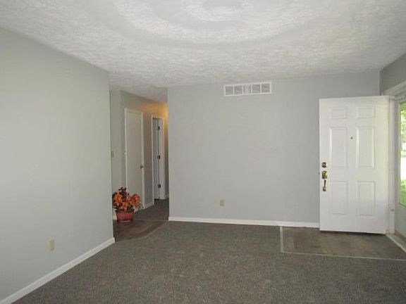 Living room with bedroom hallway.