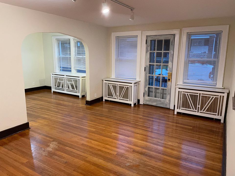 Living room looking into dining room. Custom radiator covers.
