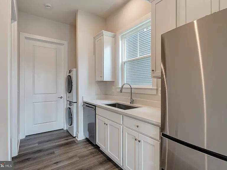 Kitchen / Pantry with full size refrigerator, microwave and washer dryer