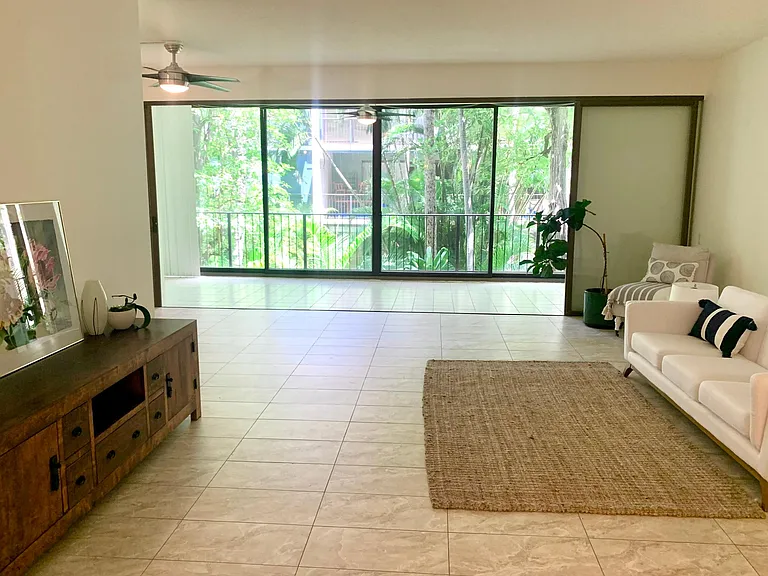 Spacious living area - with lush garden views. Sliding doors can open fully for ocean air_