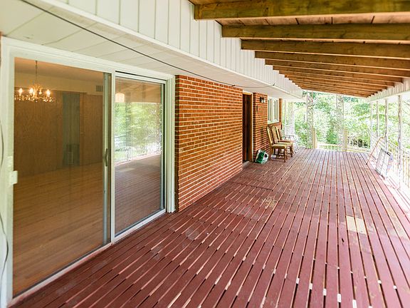 Covered back deck overlooks acres of trees