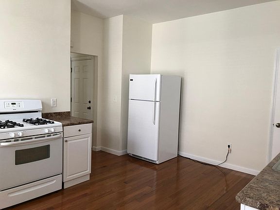 Kitchen is the center of the apartment with living room on one end and bedrooms on the other.