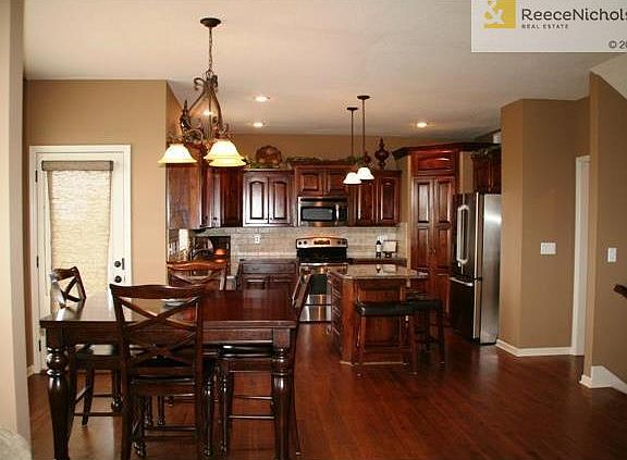 Open floor plan with beautiful hardwood floors, walk in pantry, granite counter tops and stainless steel appliances.