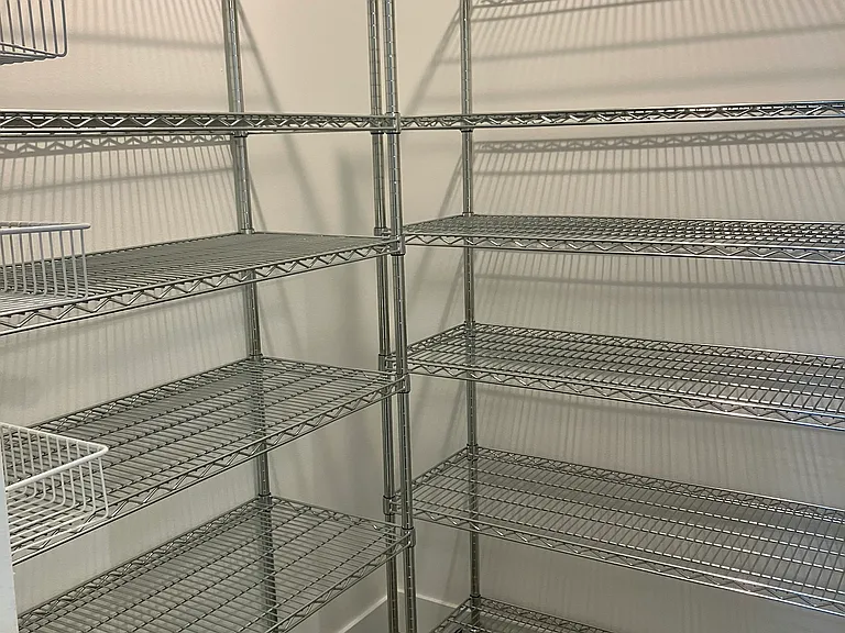Pantry behind fridge and range
