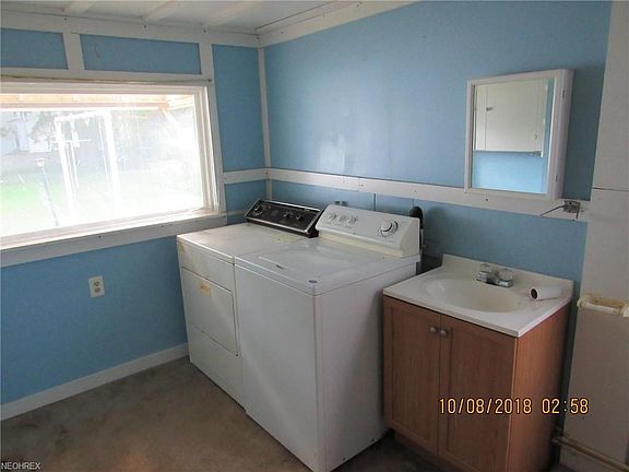 Laundry room also serves as a half bathroom.