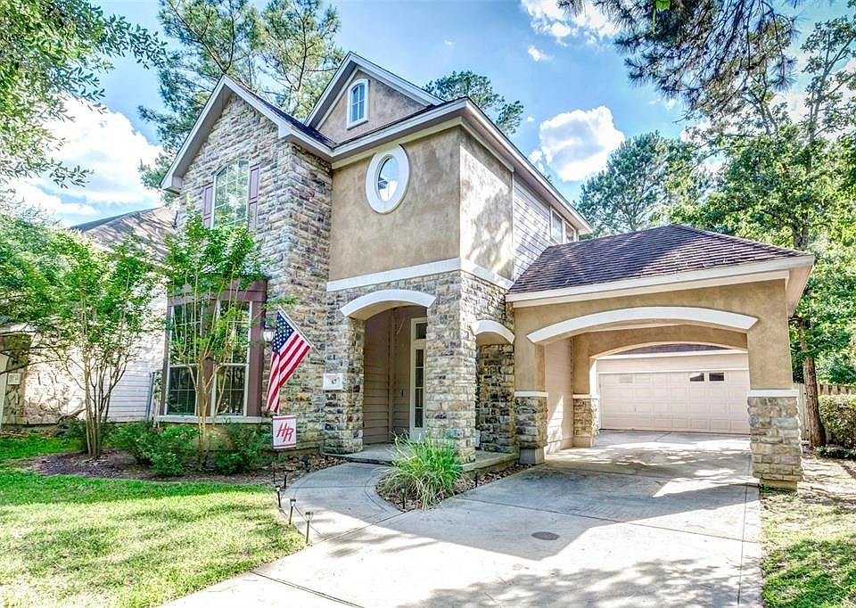 Gorgeous facade with stone and stucco as well as a convenient porte cochere at 67 S Bethany Bend.