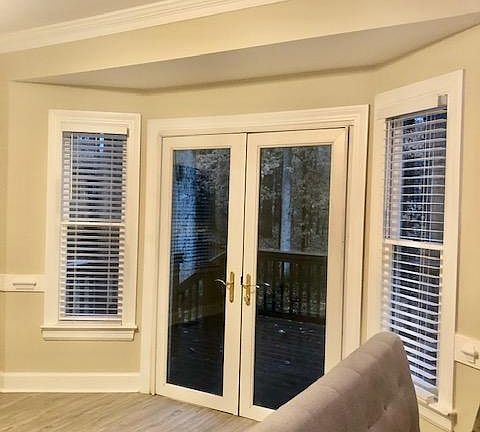 French doors to back deck before it was decorated with dining furniture .
