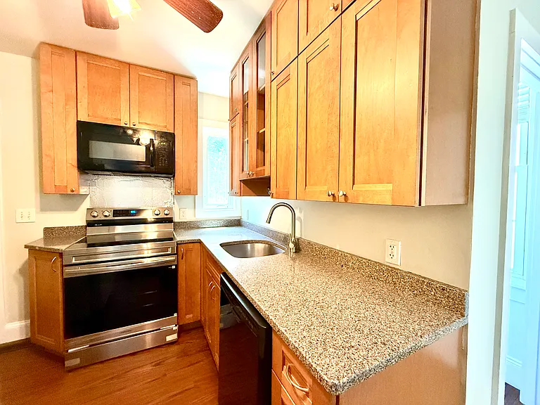 Kitchen - solid wood cabinets, granite countertops, dishwasher, microwave, oven, refrigerator (out of view)