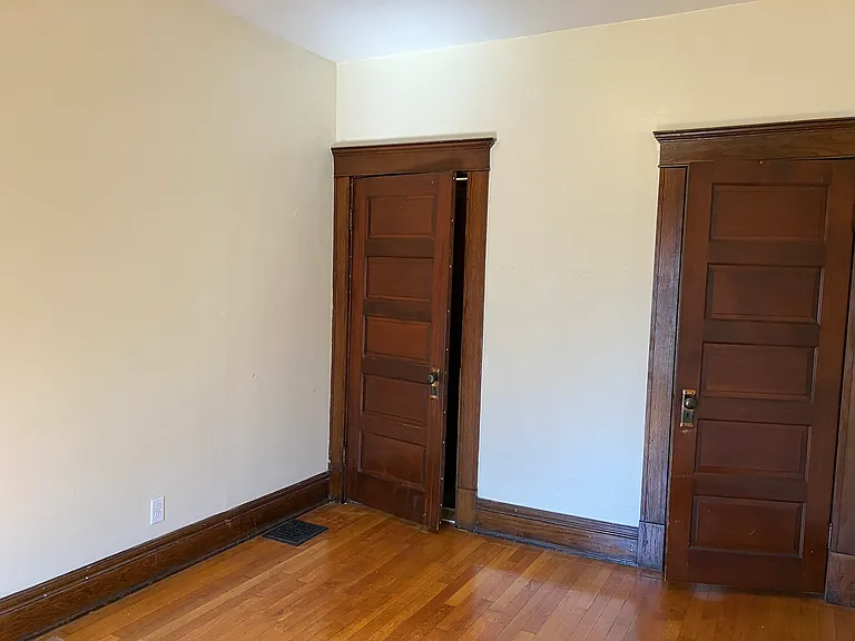Room off of living room, bath hallway door and closet door to right