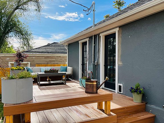 Huge new deck with bench surround and steps down to huge backyard with new fence.