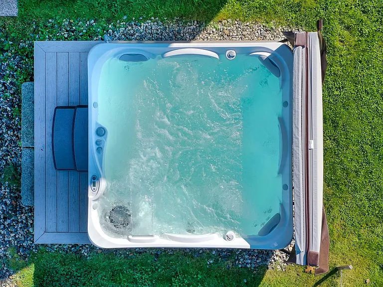 Huge new therapeutic massage hot tub stays open year round.